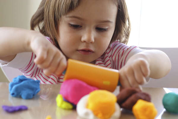 Child plays with coloured dough